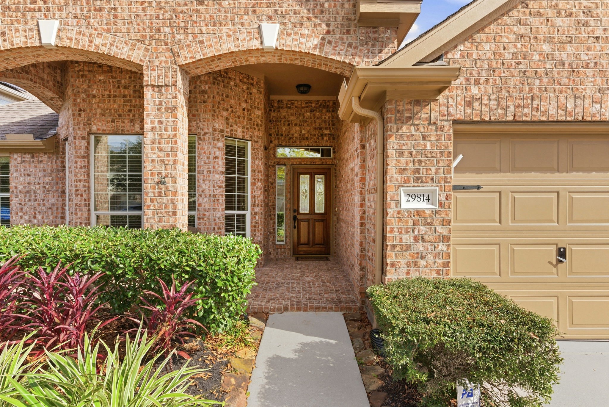 29814 Legends Pass Lane Spring, TX 77386 - Photo 7 of 46 front view of a brick house with a large window