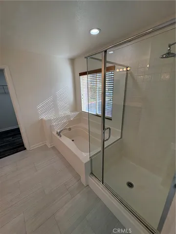 a spacious bathroom with a double vanity sink and mirror