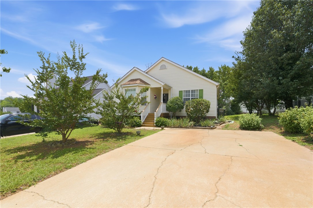 128 Kelly Lane Easley, SC 29642 - Photo 3 of 23 A well-maintained facade with green shutters welcomes you to this charming single-story residence.