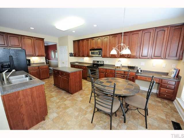 Kitchen has upgraded 42 inch cabinets. 18 upper cabinets, 15 lower cabinets,13 drawers, center work island and Chef's Desk. All open to the 2-story Family Room