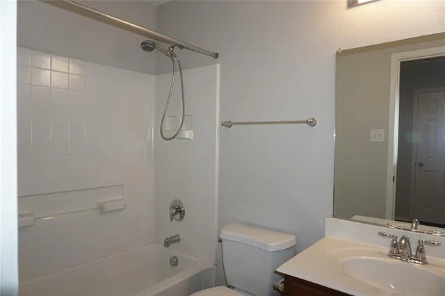 a bathroom with a shower a toilet and sink