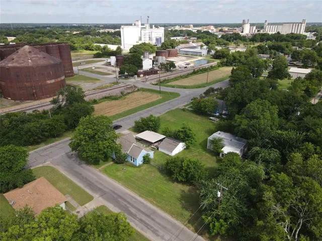 an aerial view of residential houses with outdoor space and swimming pool
