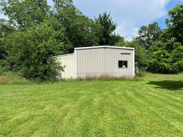 a view of a field of grass and trees