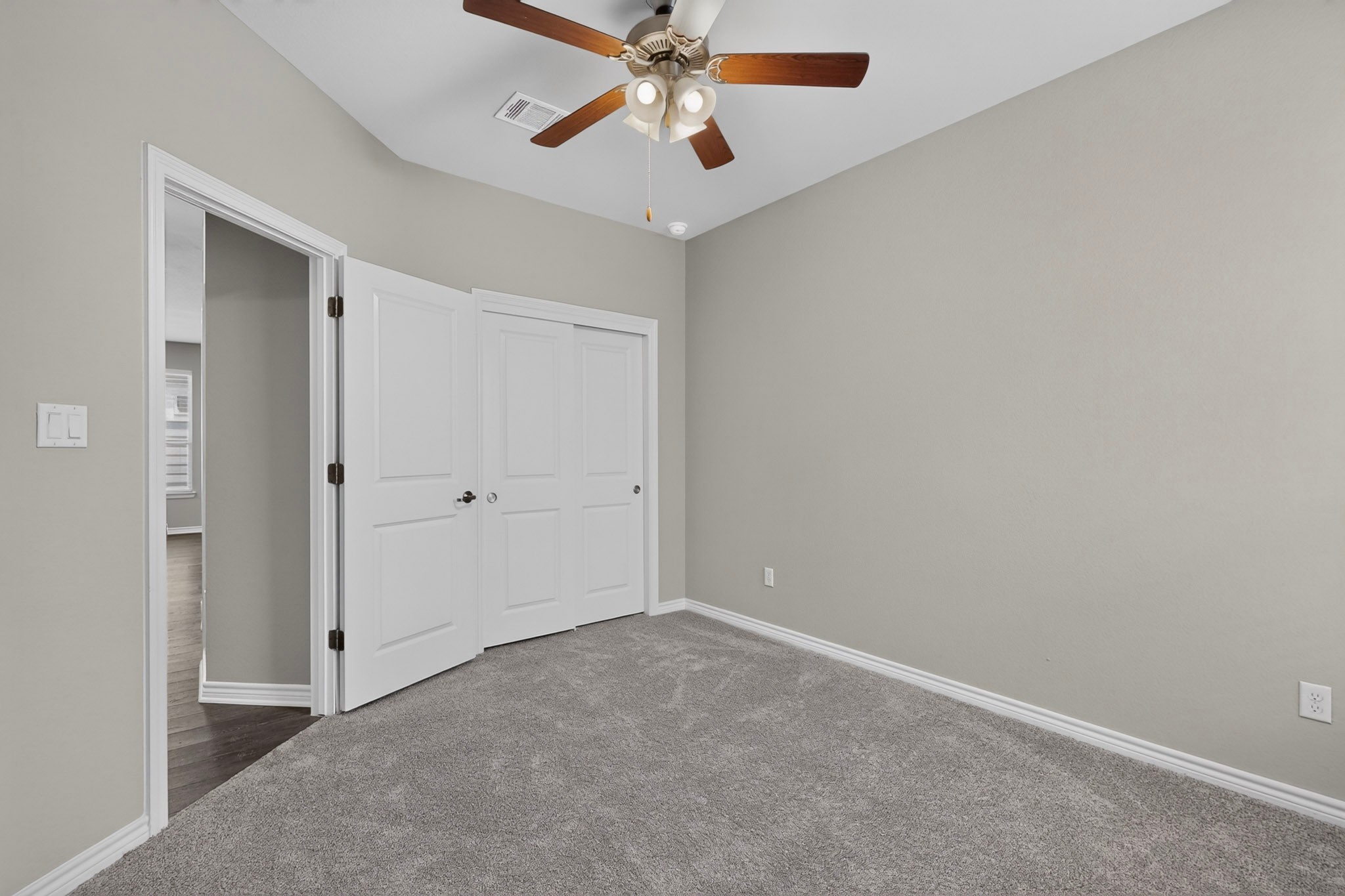 1908 Turtle Bay Loop Leander, TX 78641 - Photo 26 of 38 A well-lit bedroom features plush carpeting and a ceiling fan for comfort.