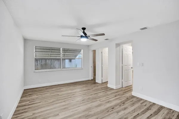 a view of wooden floor and windows in a room