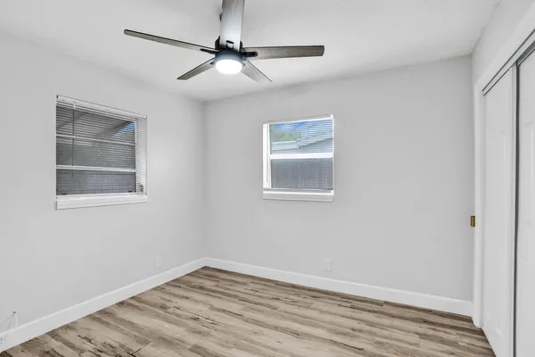 wooden floor in an empty room with a window