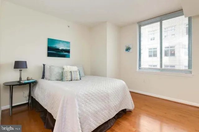 a bedroom with bed and a night stand