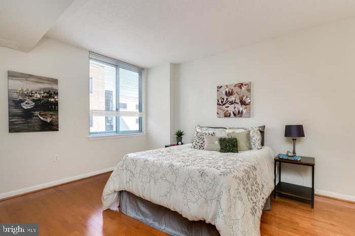 851 North Glebe Road, Unit 417 Arlington, VA 22203 - Photo 19 of 38 a bedroom with a bed and a night stand