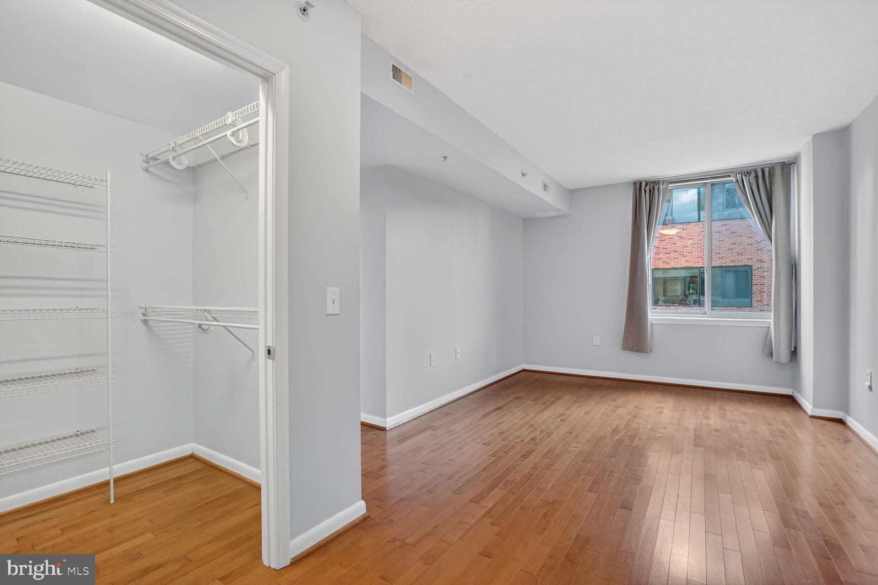 851 North Glebe Road, Unit 417 Arlington, VA 22203 - Photo 22 of 38 wooden floor in an empty room with a window
