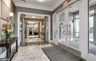 851 North Glebe Road, Unit 417 Arlington, VA 22203 - Photo 30 of 38 a view of a hallway with wooden floor and a living room