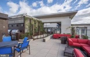 851 North Glebe Road, Unit 417 Arlington, VA 22203 - Photo 33 of 38 a swimming pool with outdoor seating and yard