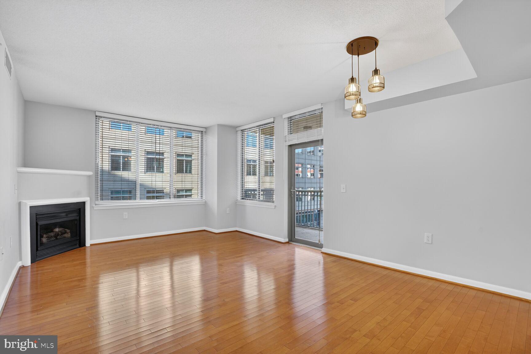 851 North Glebe Road, Unit 417 Arlington, VA 22203 - Photo 4 of 38 a view of an empty room with a window and wooden floor