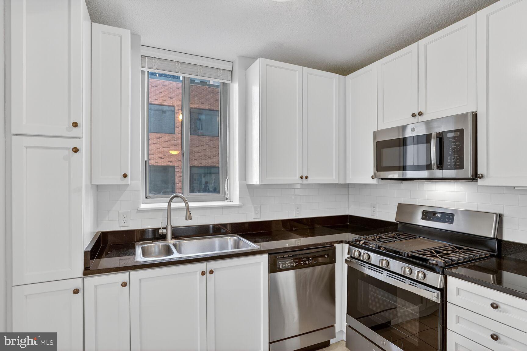 851 North Glebe Road, Unit 417 Arlington, VA 22203 - Photo 10 of 38 a kitchen with stainless steel appliances granite countertop a sink and a stove