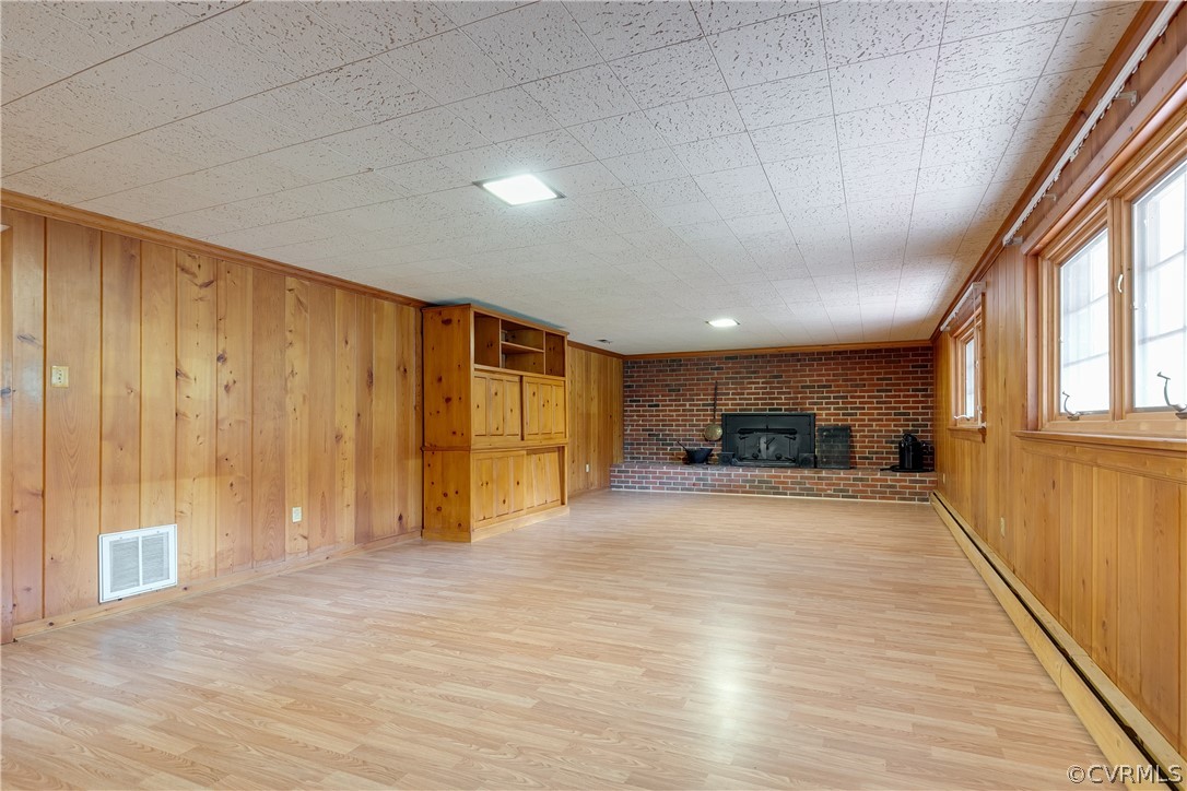 8946 Cherokee Road Richmond, VA 23235 - Photo 12 of 30 a view of an empty room with wooden floor and a window