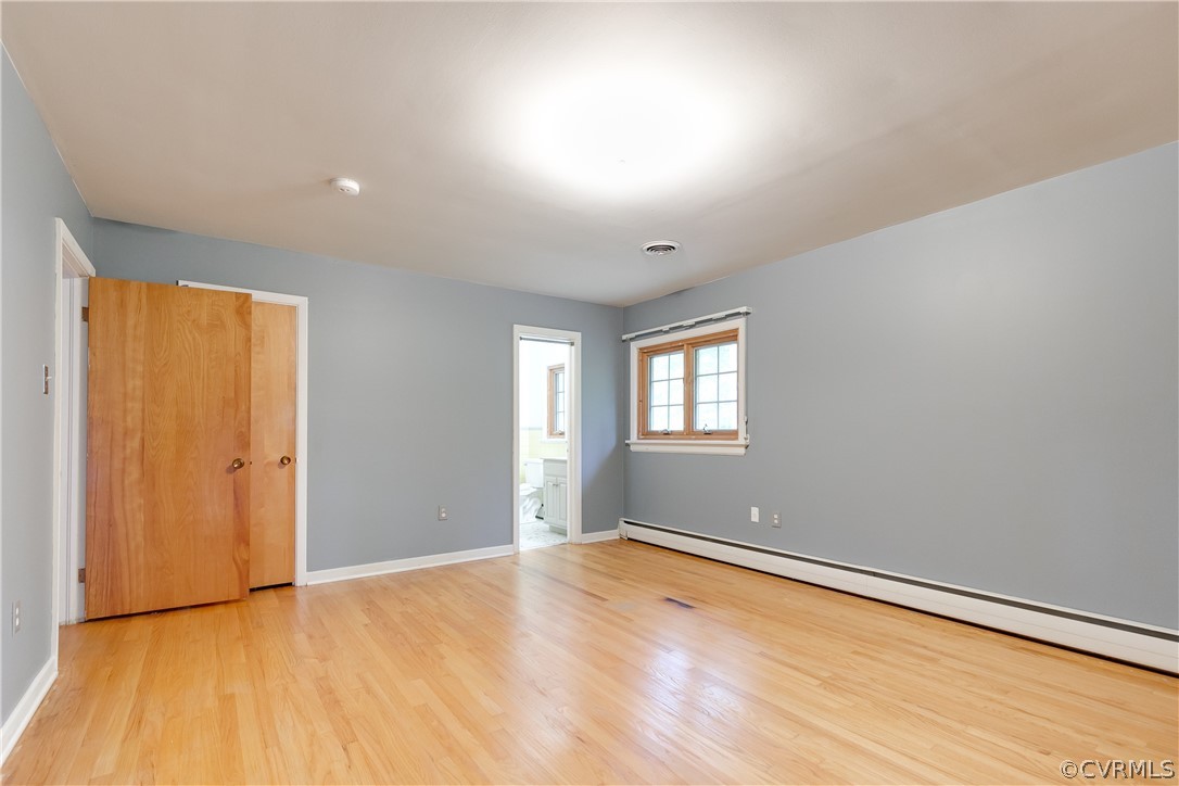 8946 Cherokee Road Richmond, VA 23235 - Photo 18 of 30 a view of empty room with wooden floor and fan