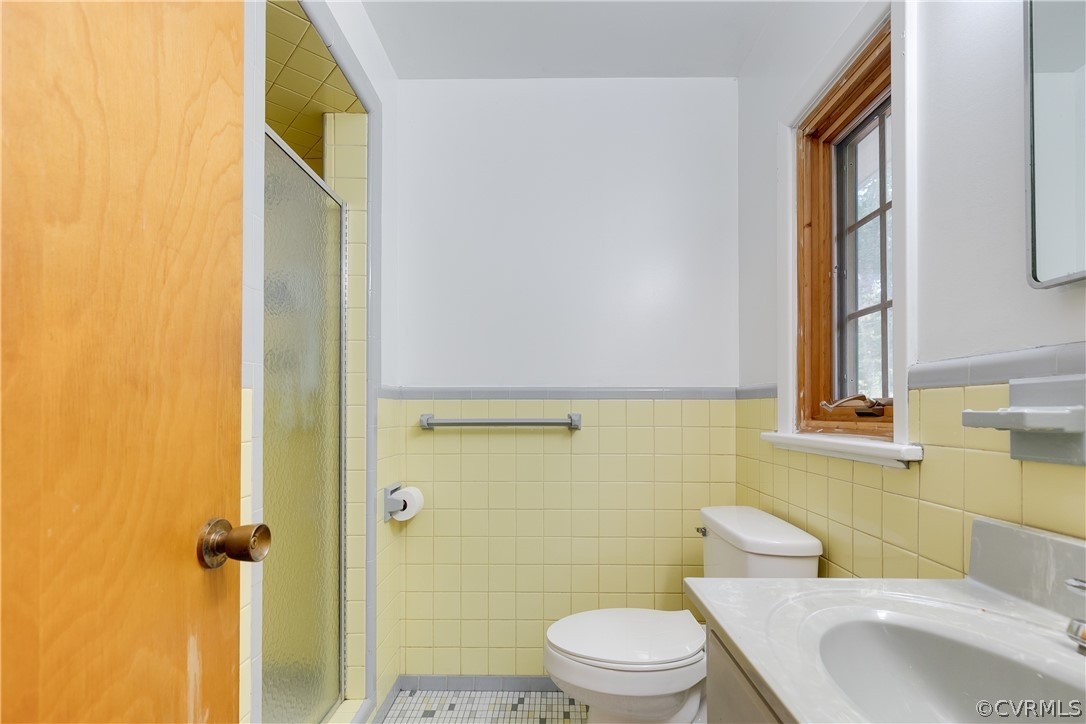 8946 Cherokee Road Richmond, VA 23235 - Photo 20 of 30 a white toilet sitting next to a bathroom sink