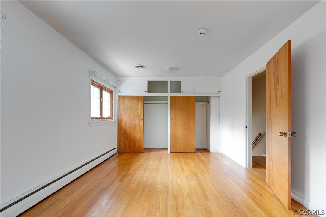 8946 Cherokee Road Richmond, VA 23235 - Photo 22 of 30 wooden floor in an empty room with a window