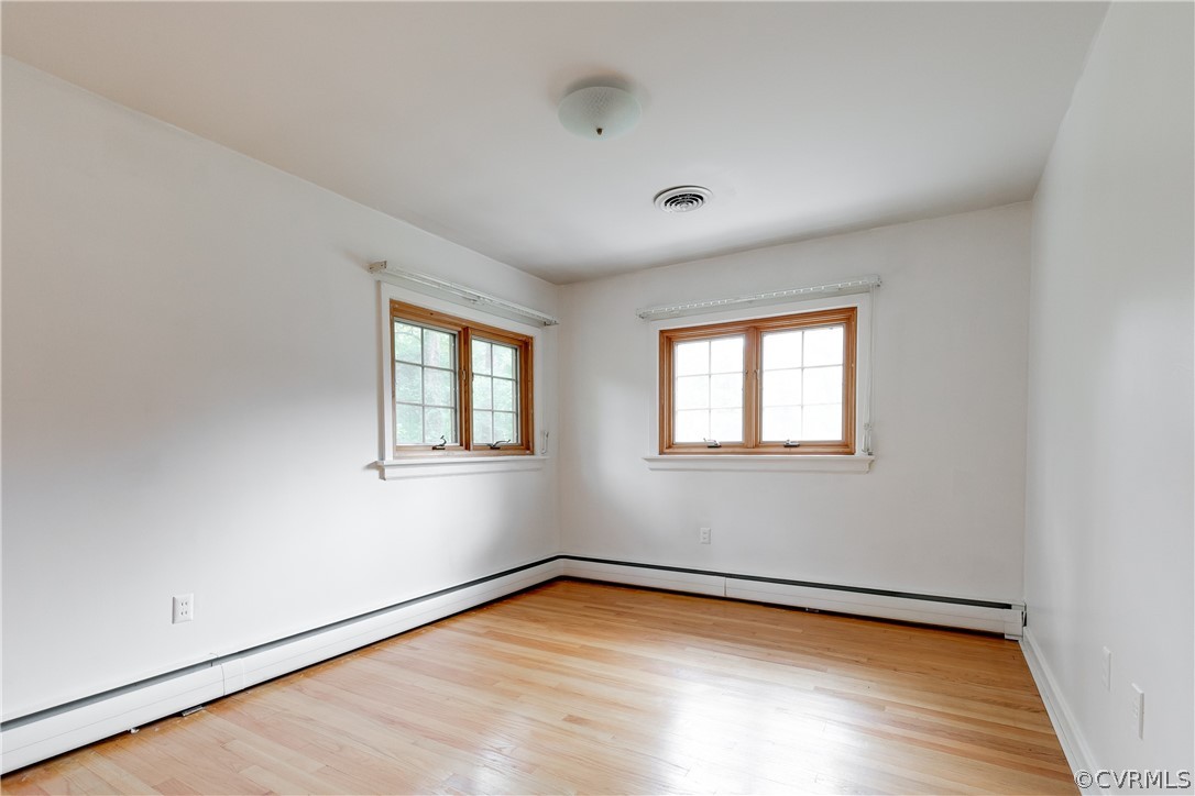 8946 Cherokee Road Richmond, VA 23235 - Photo 23 of 30 a view of empty room with wooden floor and fan