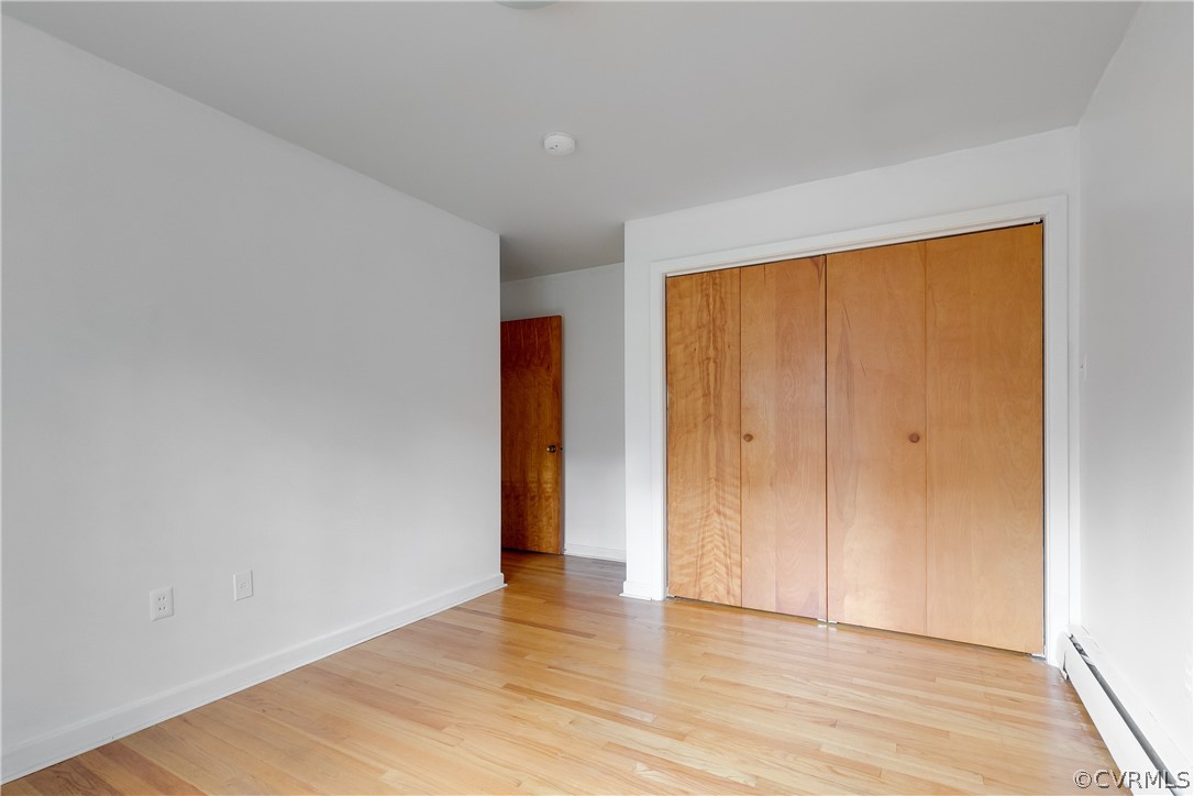 8946 Cherokee Road Richmond, VA 23235 - Photo 24 of 30 a view of an empty room with wooden floor and a window