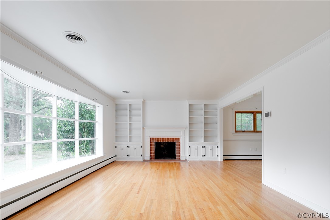 8946 Cherokee Road Richmond, VA 23235 - Photo 3 of 30 an empty room with windows and fireplace