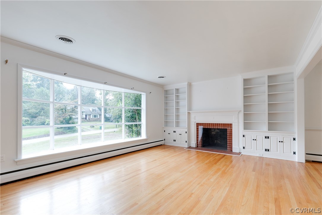 8946 Cherokee Road Richmond, VA 23235 - Photo 4 of 30 a view of an empty room with a fireplace and a window
