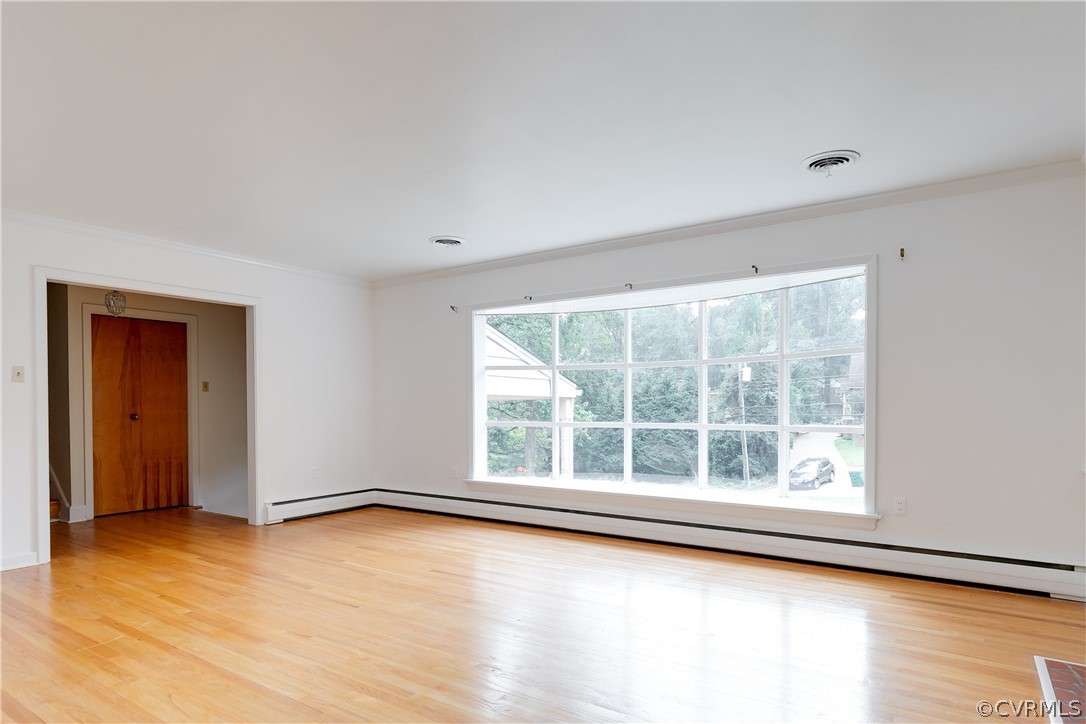 8946 Cherokee Road Richmond, VA 23235 - Photo 6 of 30 an empty room with wooden floor and windows