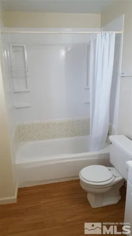 a bathroom with a toilet and a bathtub