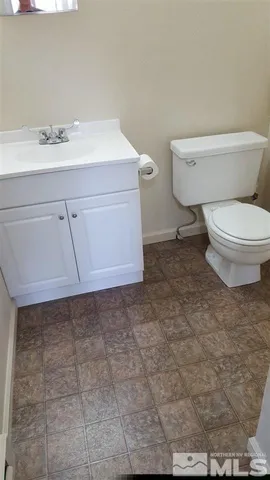 a bathroom with a sink a toilet and vanity