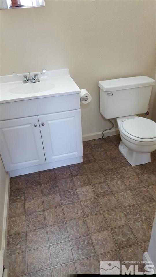 126 E Street Hawthorne, NV 89415 - Photo 6 of 14 a bathroom with a sink a toilet and vanity