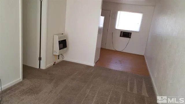 a room with computer on a table and chair