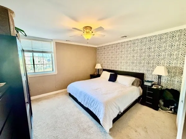 a bedroom with a bed and a night stand