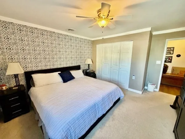 a bedroom with a bed and a mirror