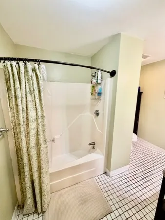 a bathroom with a bathtub and a shower