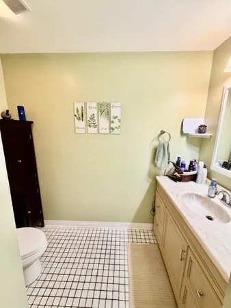 a bathroom with a sink a toilet and a mirror