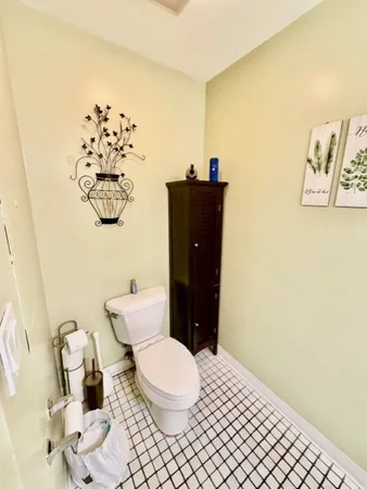 a bathroom with a toilet and a shower curtain