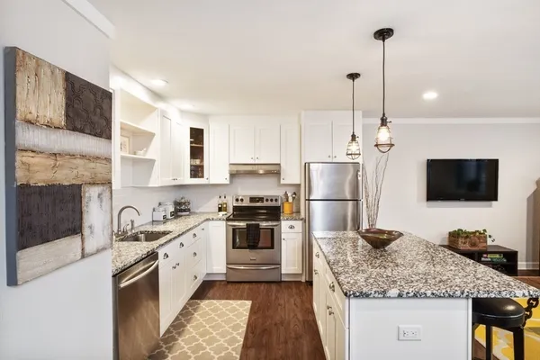a kitchen with a sink stove and refrigerator