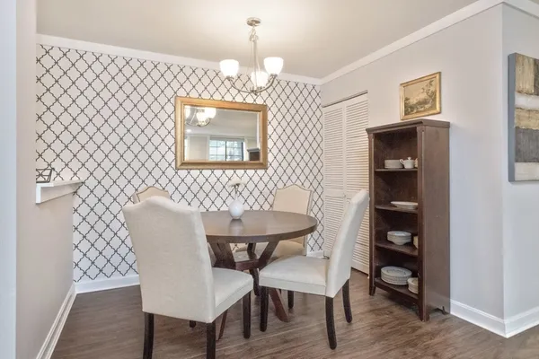 a view of a dining room with furniture and wooden floor
