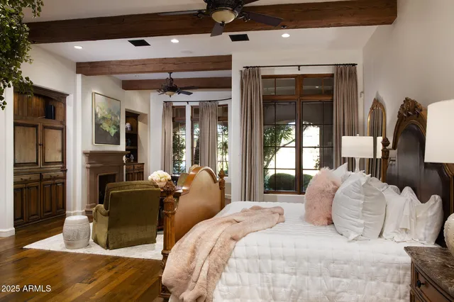 a living room with couches and a potted plant with four windows