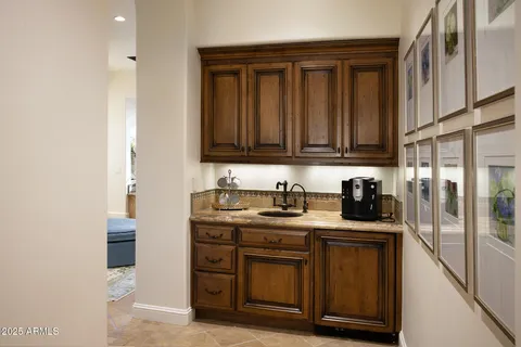 a view of a patio with couple of chairs and a fire pit