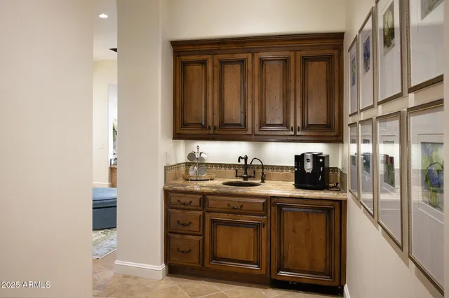 a view of a patio with couple of chairs and a fire pit