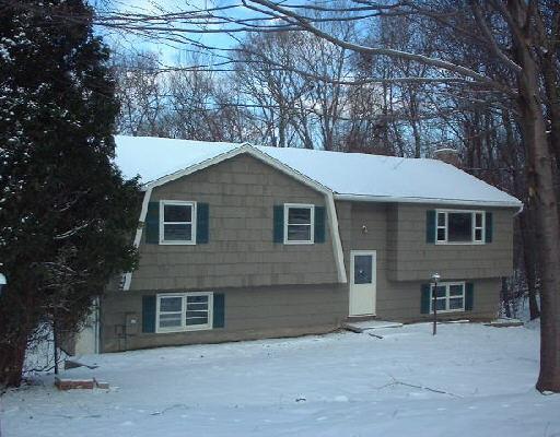 a view of a yard in front of a house with large tree