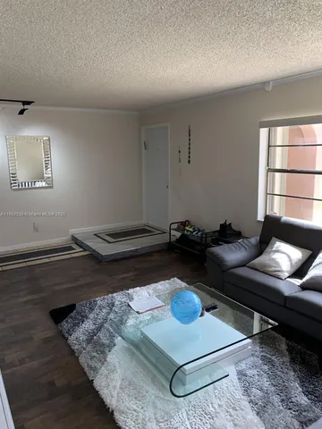 a room with furniture pool table and window