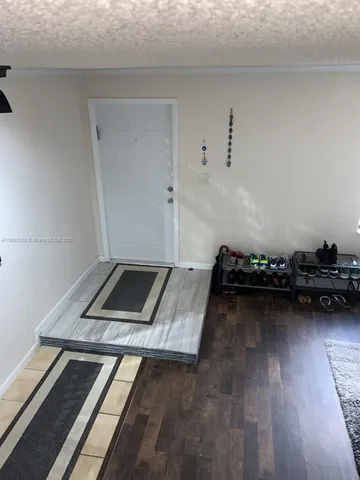 a bathroom with a granite countertop sink and a toilet