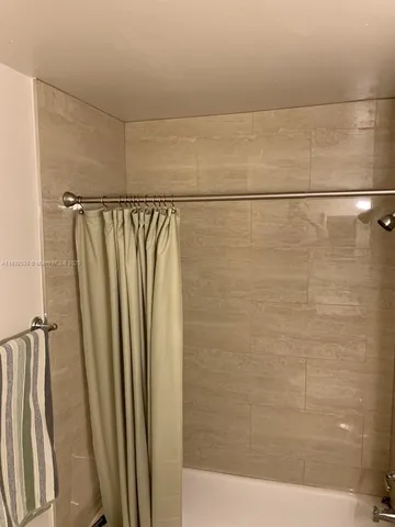 a bedroom with a bed and ceiling fan