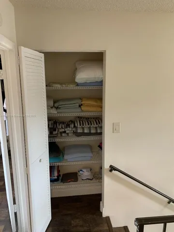 a living room with furniture and a walk in closet