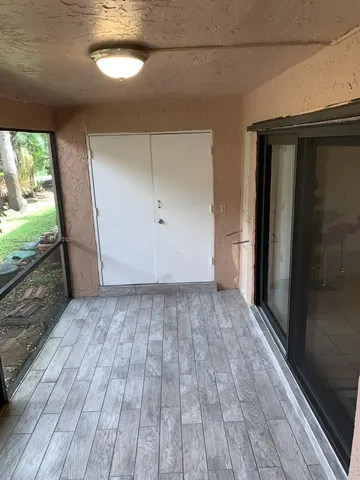a front view of a house with garden and trees