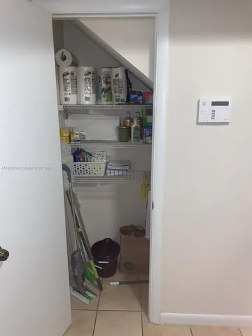 a room with a wooden floor and cabinets