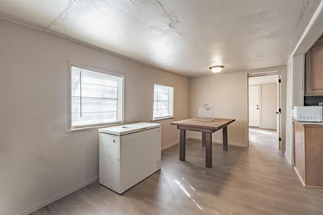 a kitchen with stainless steel appliances granite countertop a stove a sink dishwasher and a refrigerator with wooden floor