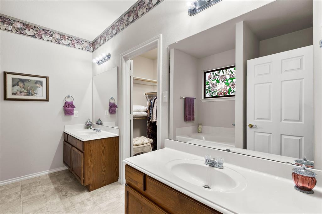3505 Austin Street Gainesville, TX 76240 - Photo 11 of 20 a bathroom with a sink vanity and mirror