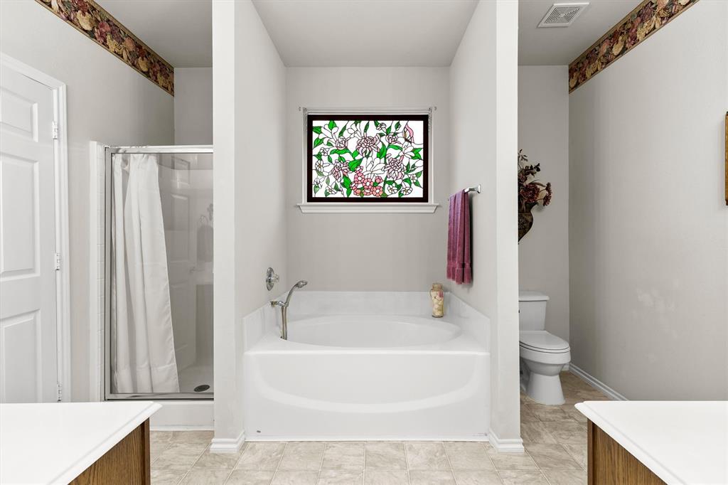 3505 Austin Street Gainesville, TX 76240 - Photo 12 of 20 a white bath tub sitting next to a white toilet